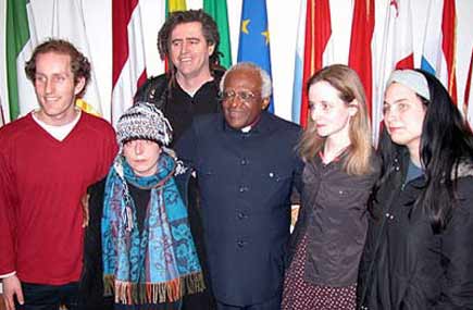 Damien Moran at left stands with his fellow Shannon Airport defendants and Archbishop Desmond Tutu.
